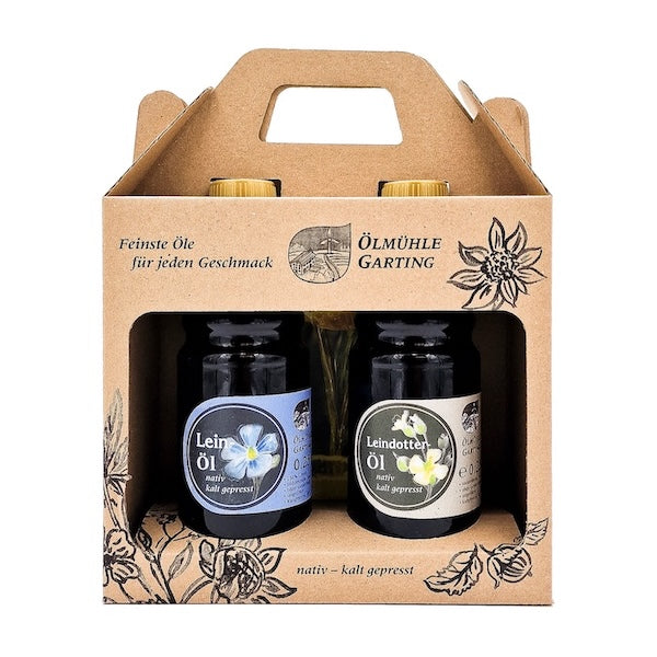 Geschenkset die Leinigen kaltgepresst nativ mit 250 ml Flasche Leinöl und 250 ml Flasche Leindotteröl in einer Karton
tasche auf weißem Hintergrund
